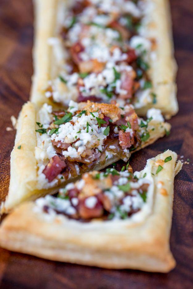 Bacon blue cheese caramelized onion tart on puff pastry, topped with onions, bacon, crumbled cheese and herbs