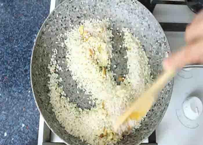 Dry cooking the rice for the garlic rice with fish recipe
