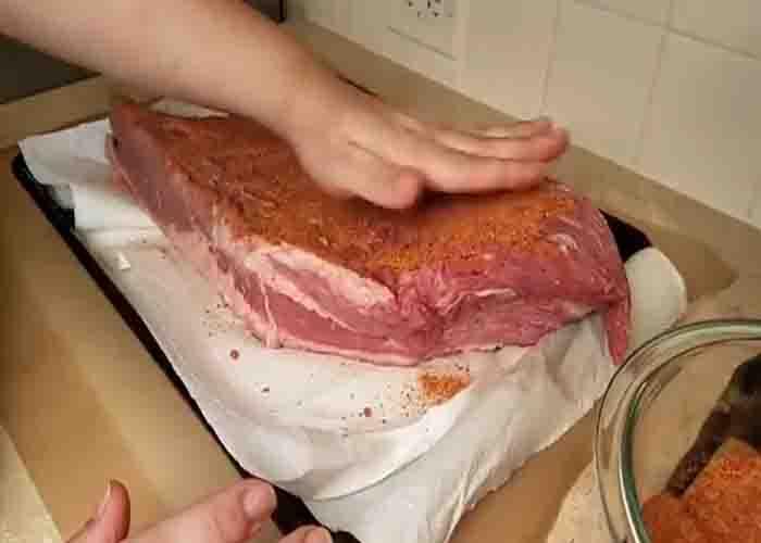 Rubbing the homemade seasoning into the brisket