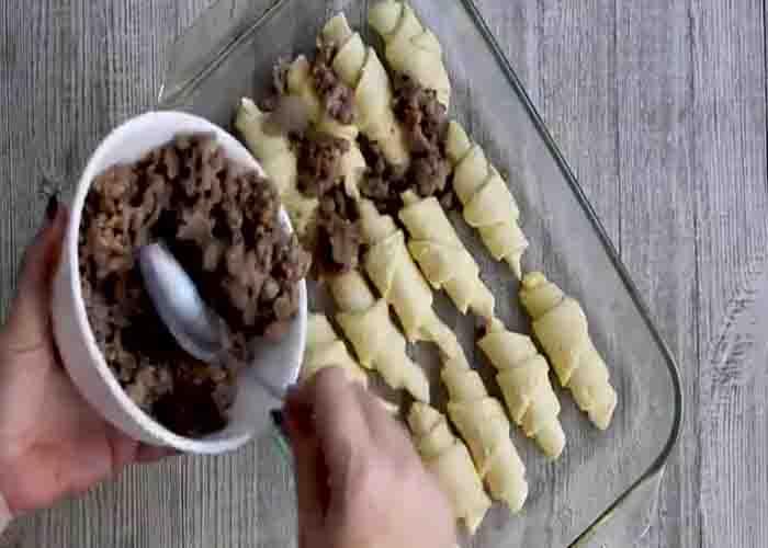 Layering the sausage crescent roll casserole