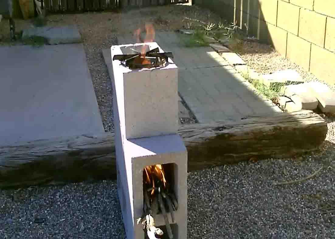 Placing twigs to heat up the cinder block rocket stove