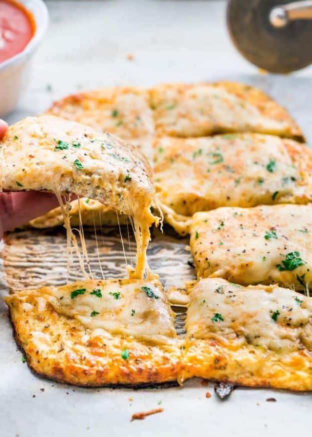 Cheesy cauliflower breadsticks cut into strips and pulled apart, a gluten free low carb appetizer recipe
