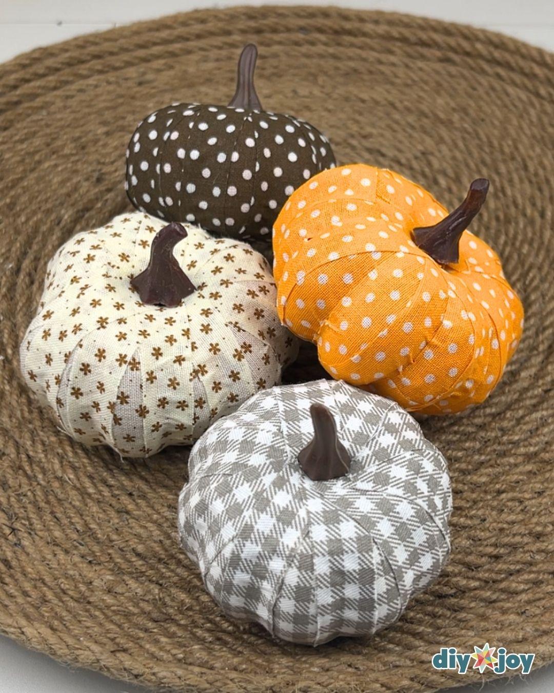 Fall Decor Ideas - four fabric wrapped pumpkins in brown polka dot, orange, cream floral and gray gingham arranged together