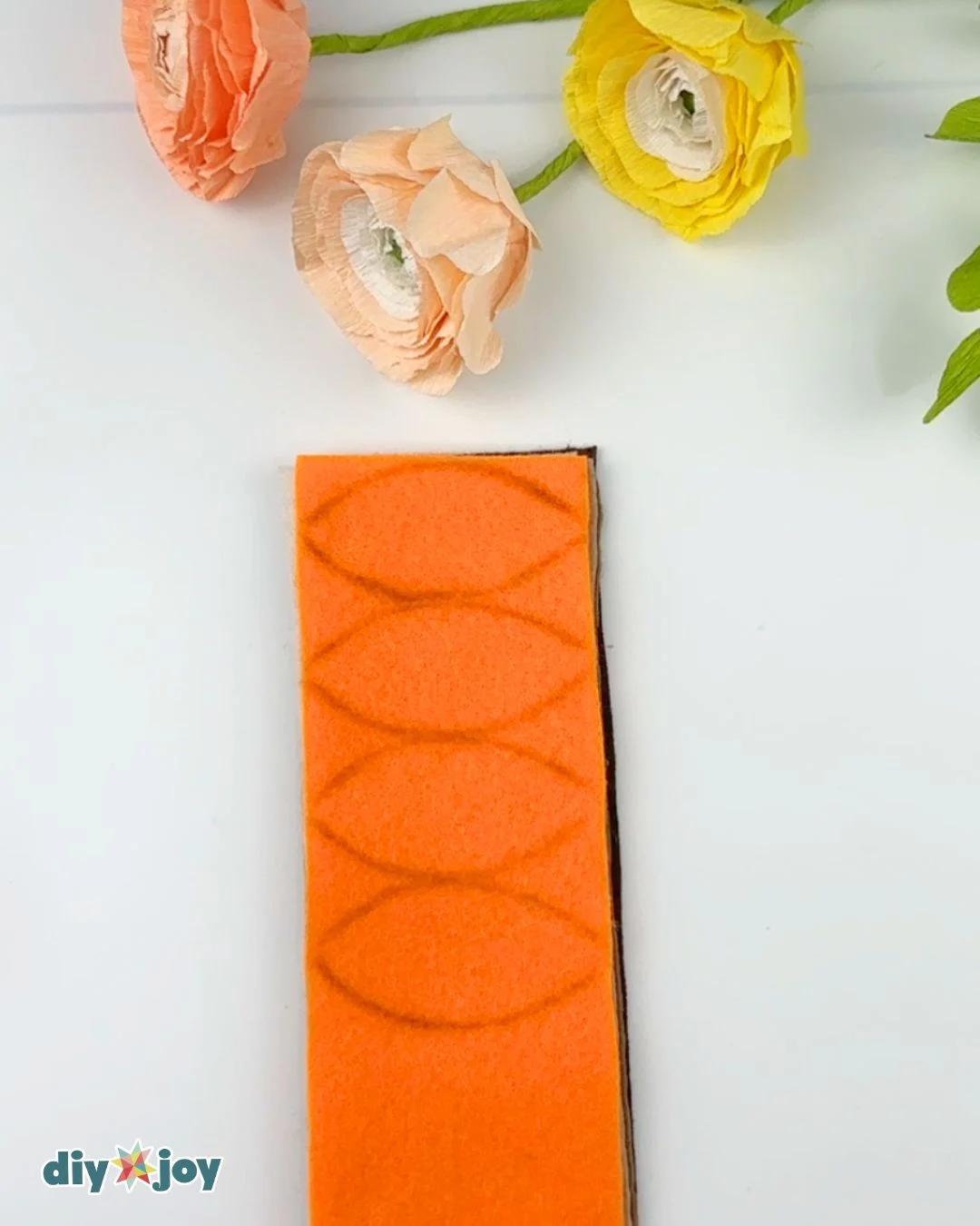 Fall wreath tutorial - felt sheets stacked and traced with a leaf pattern ready to cut, before cutting the layers.