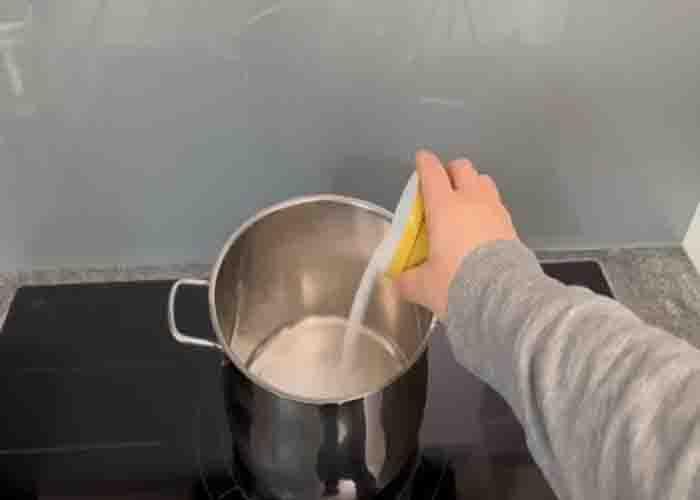 Adding salt to a large pot of water
