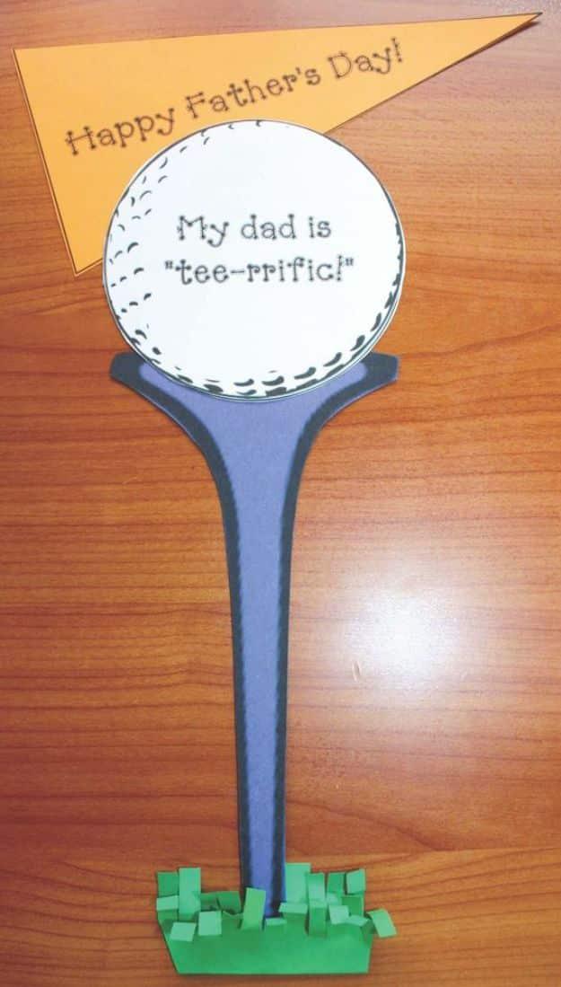 Golf tee Father's Day card, a paper ball reading my dad is tee-rrific on a blue tee with cut paper grass