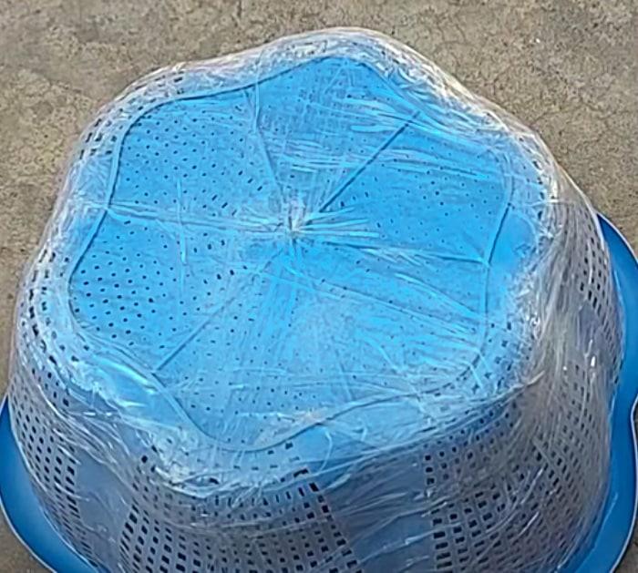 A plastic laundry basket oiled and wrapped in packing tape as a mold, the first step in casting concrete planters