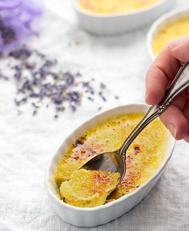 Lavender creme brulee in a white ramekin with a cracked caramelized sugar top and dried lavender scattered