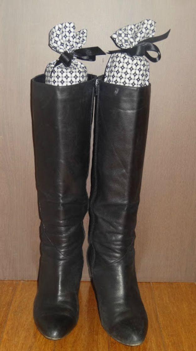 Easy boot shapers, tall black leather boots standing upright with patterned fabric boot shapers inside