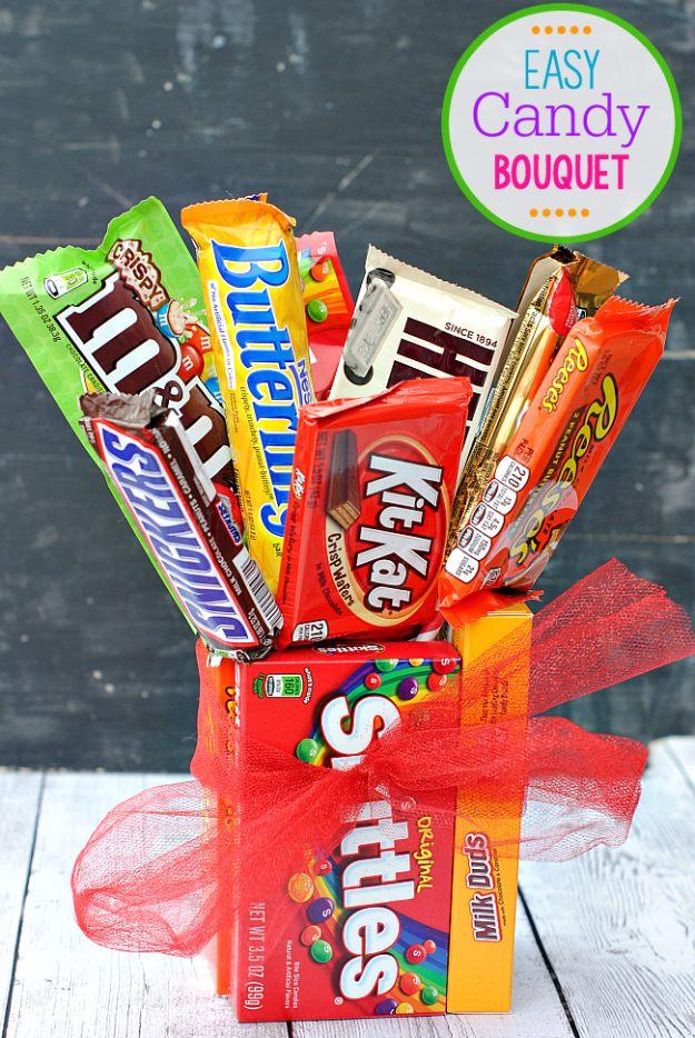 A bouquet of candy bars on sticks arranged in a base of candy boxes, a fun DIY Valentine gift idea for her