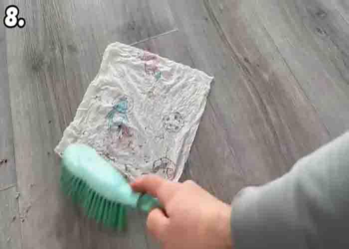 Sweeping the floor with wet kitchen towel