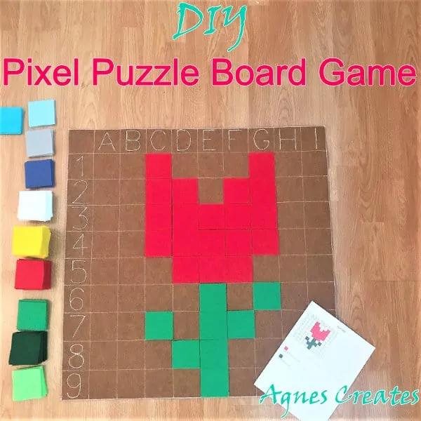 A felt pixel puzzle board with a lettered grid, a red tulip built from felt squares and a stack of colored felt tiles