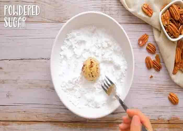 Coating the butterballs with powdered sugar