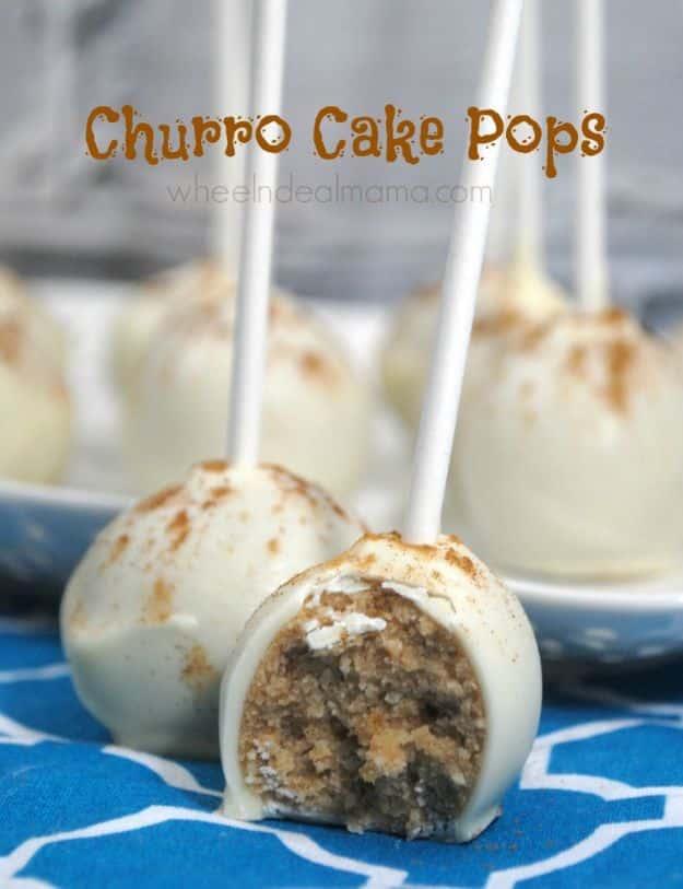 Churro cake pops rolled in cinnamon sugar and dipped in white chocolate for a fair food dessert treat, standing in a block