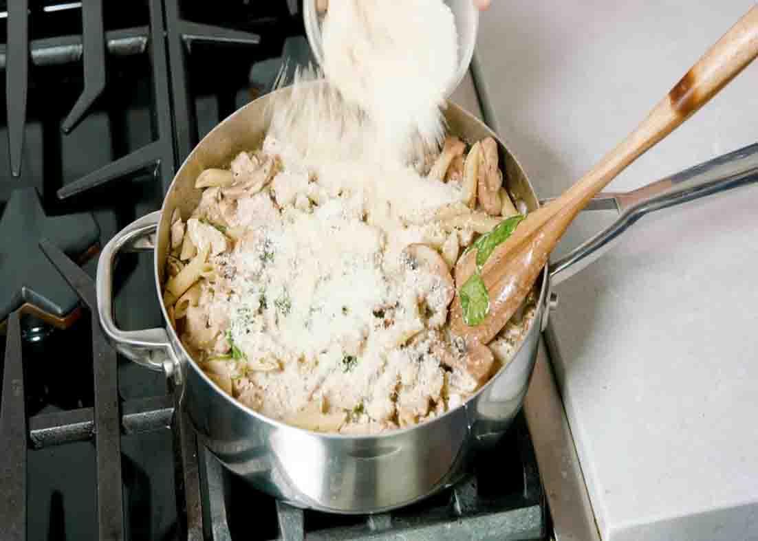 Adding some parmesan cheese to the chicken and pasta recipe