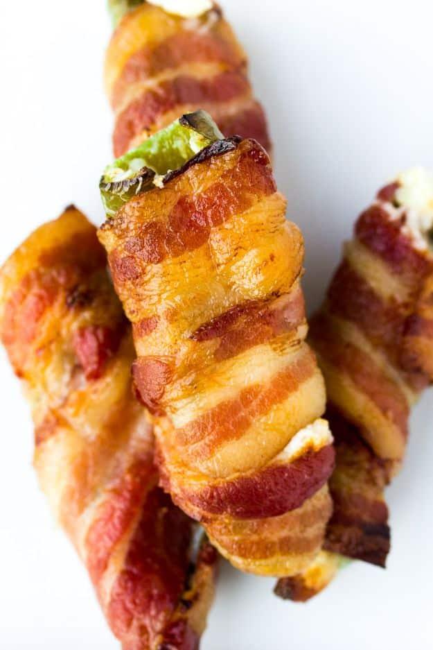 Double bacon jalapeno poppers, bacon wrapped jalapeno halves stuffed with cheese, crisped and stacked on white