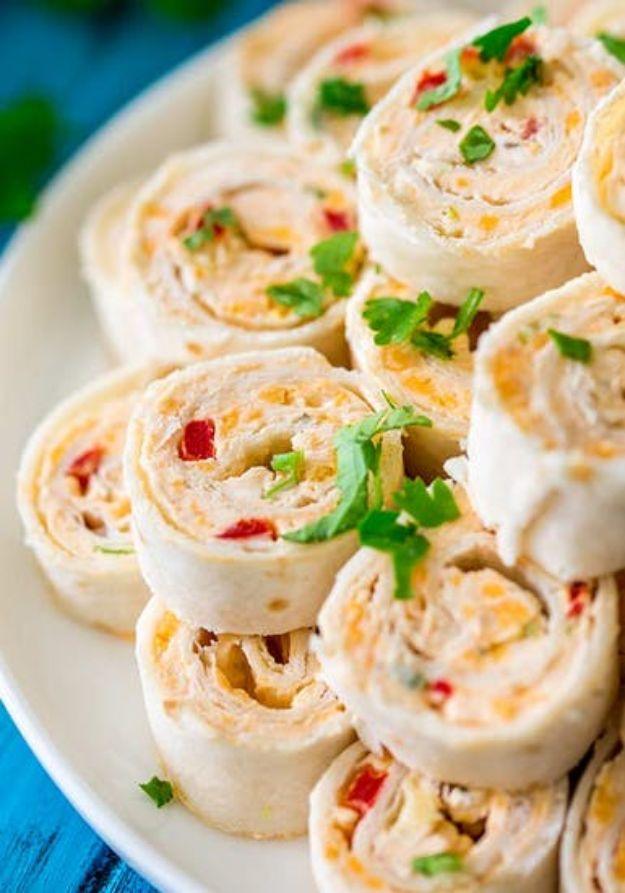 Vegetarian Mexican pinwheels sliced into spirals showing cream cheese filling with red pepper and green chili