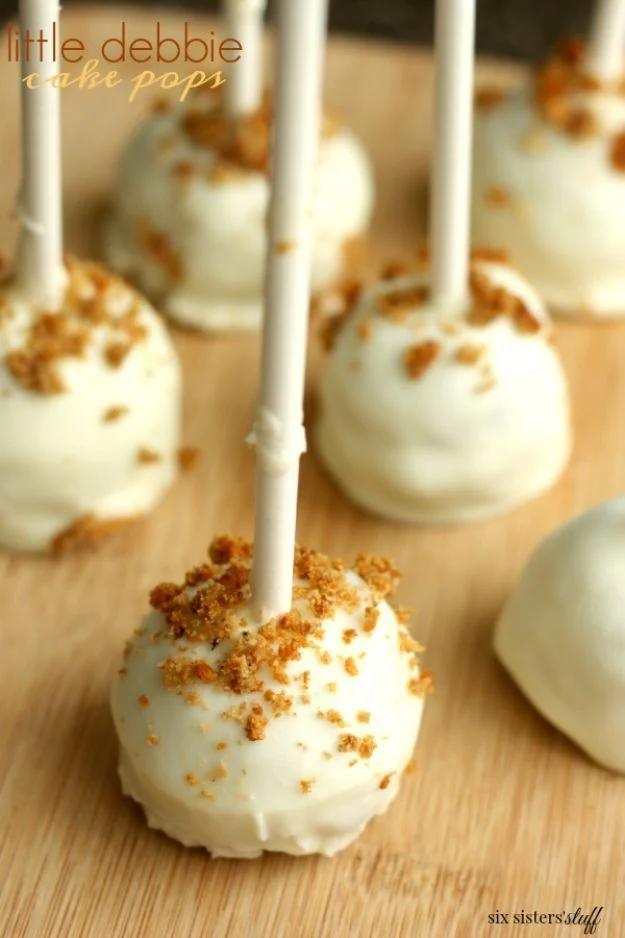 Little Debbie cake pops made from oatmeal cream pies and dipped in white chocolate with crumbs and sprinkles, a quick treat