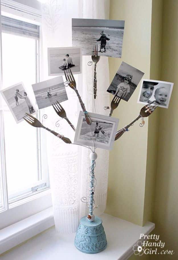 Six forks on beaded wire stems in a painted wooden base, each holding a black and white family photo