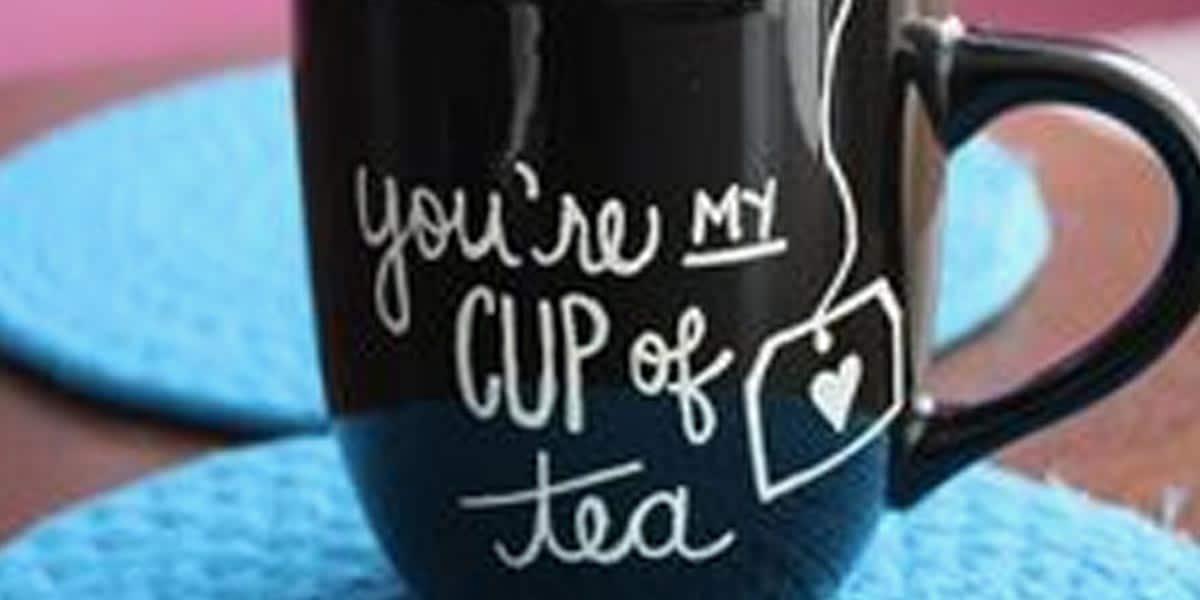 DIY sharpie mug, a black mug lettered in white with the words you are my cup of tea and a small tea bag doodle