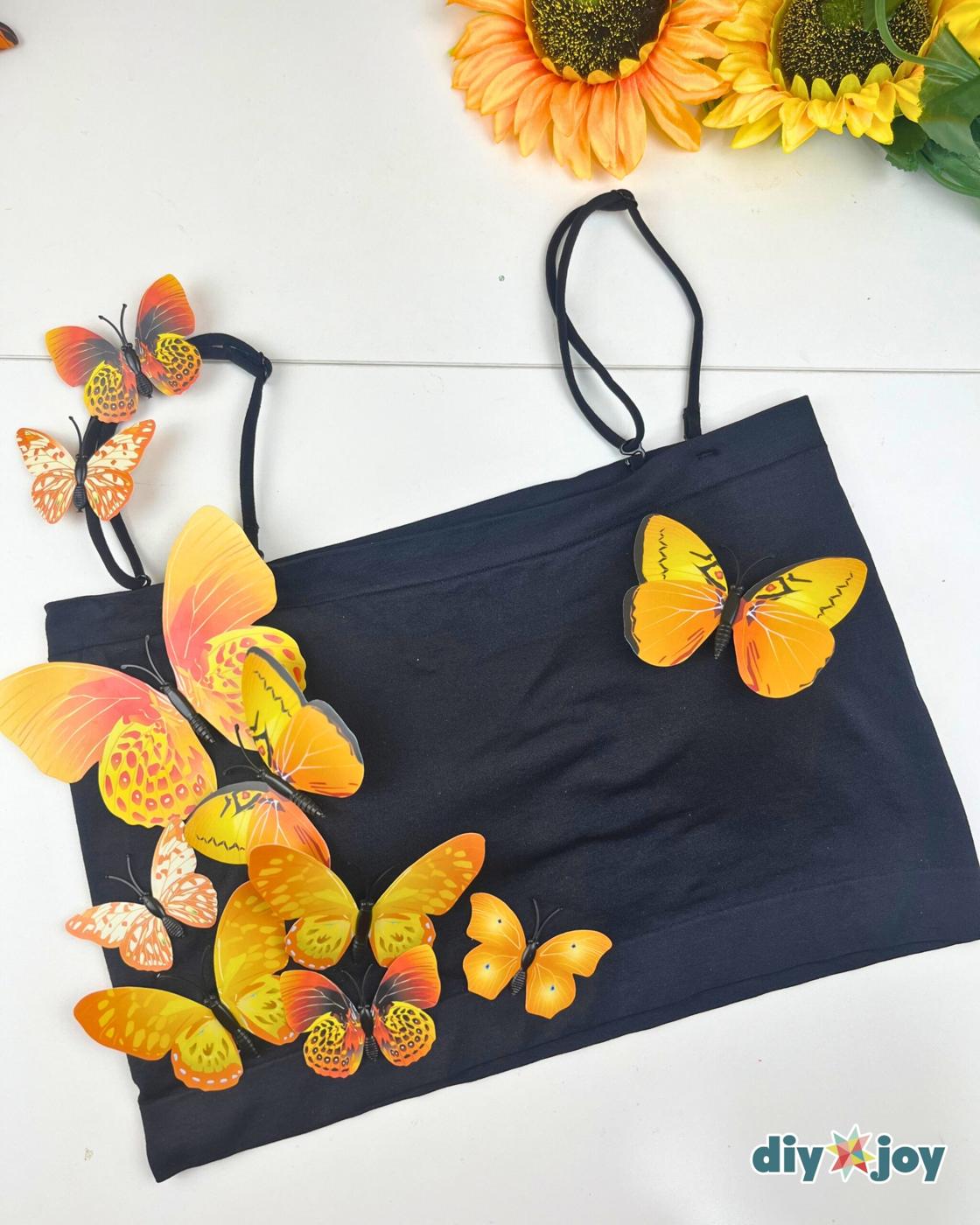 Cheap DIY Costume Ideas - proof that easy Halloween costumes start with a black crop top and fake butterflies.