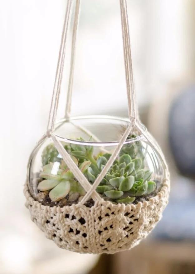 A terrarium hanger knit to cradle a small plant for a hanging handmade display gift for the whole family