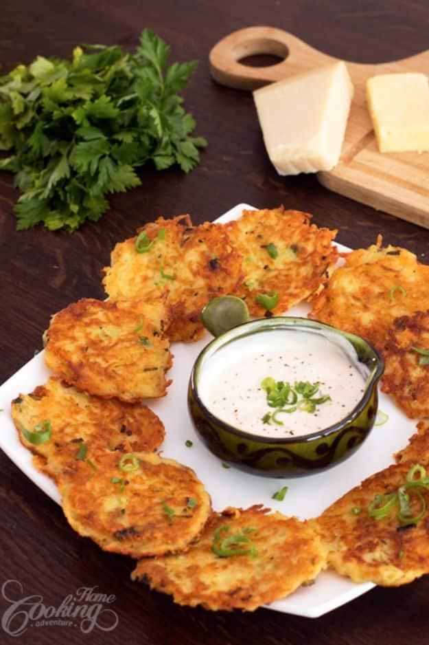 Cheese potato pancakes, crisp golden grated potato fritters arranged around a small bowl of white dip