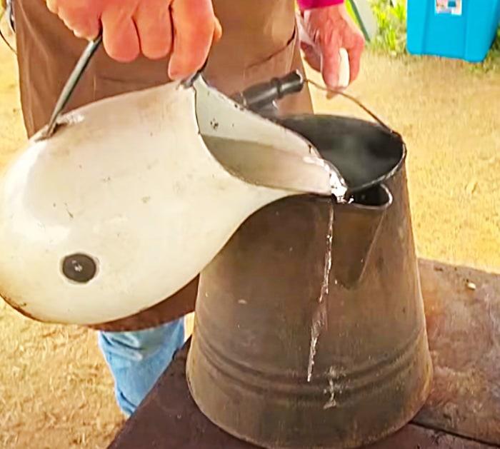 Pour Cold Water Into The Cowboy Coffee To Settle The Coffee Grains To The Bottom