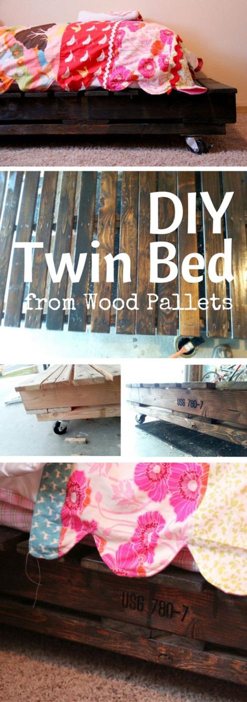 Twin bed frame built from two stained wood pallets on casters with 2x4 supports and bright bedding on top