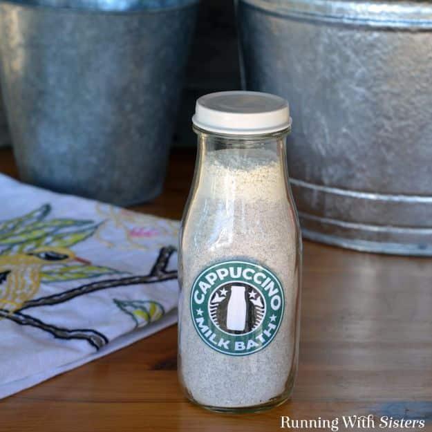 Cappuccino milk bath, a glass milk bottle of pale bath powder with a round green label beside galvanized buckets