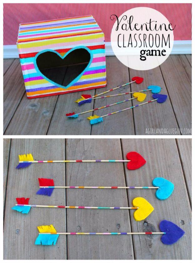 Valentine classroom party game board painted pink with a cut out heart hole and arrows waiting for a turn