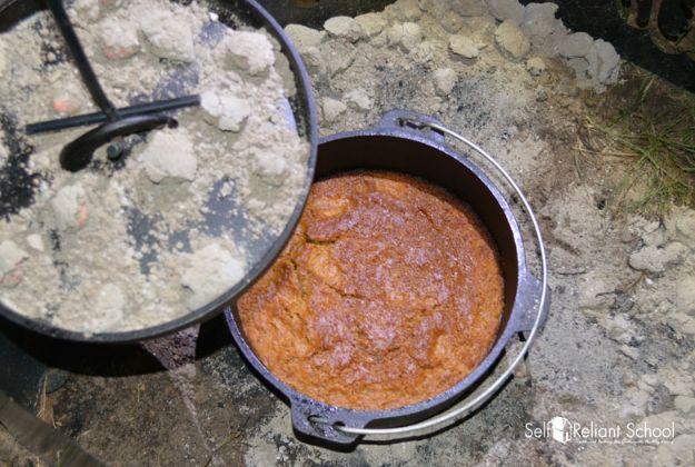 Pumpkin pie baked in a dutch oven over hot coals, with a set custard filling and a browned crust edge