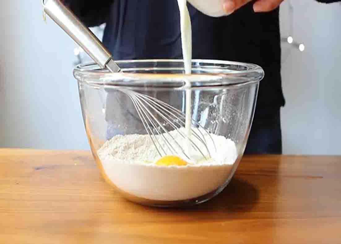 Mixing all the ingredients for the bakery-style blueberry muffins