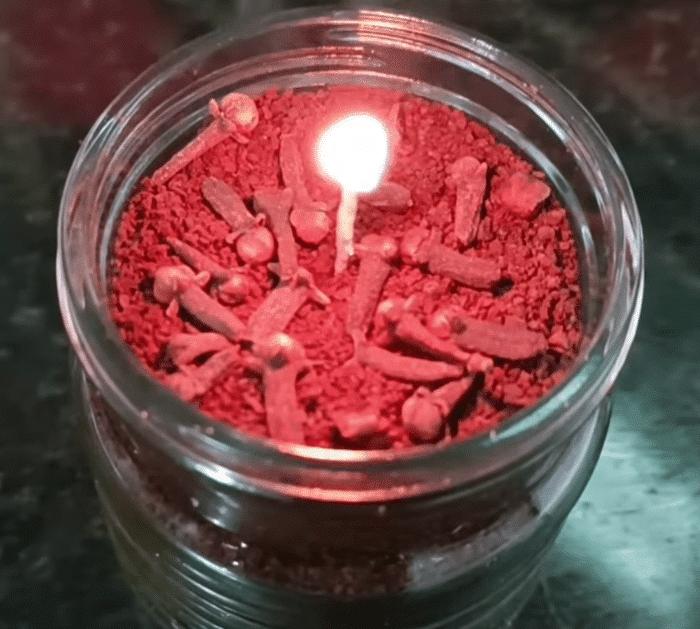 Coffee, cloves, and candle in a jar