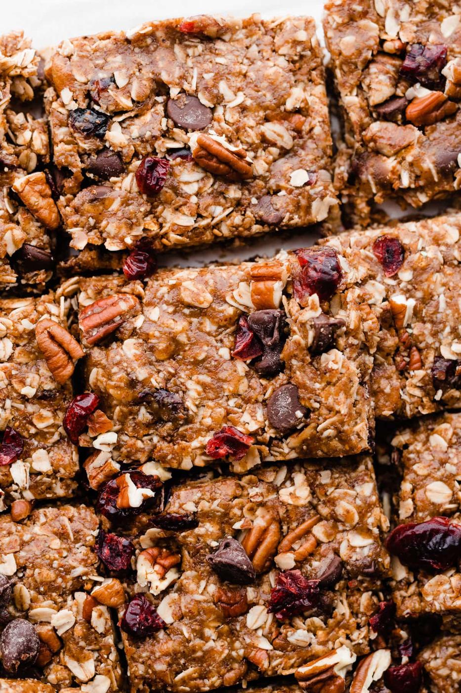 No bake granola bars packed with oats, pecans, dried cranberries and chocolate chips, cut into squares for lunchboxes