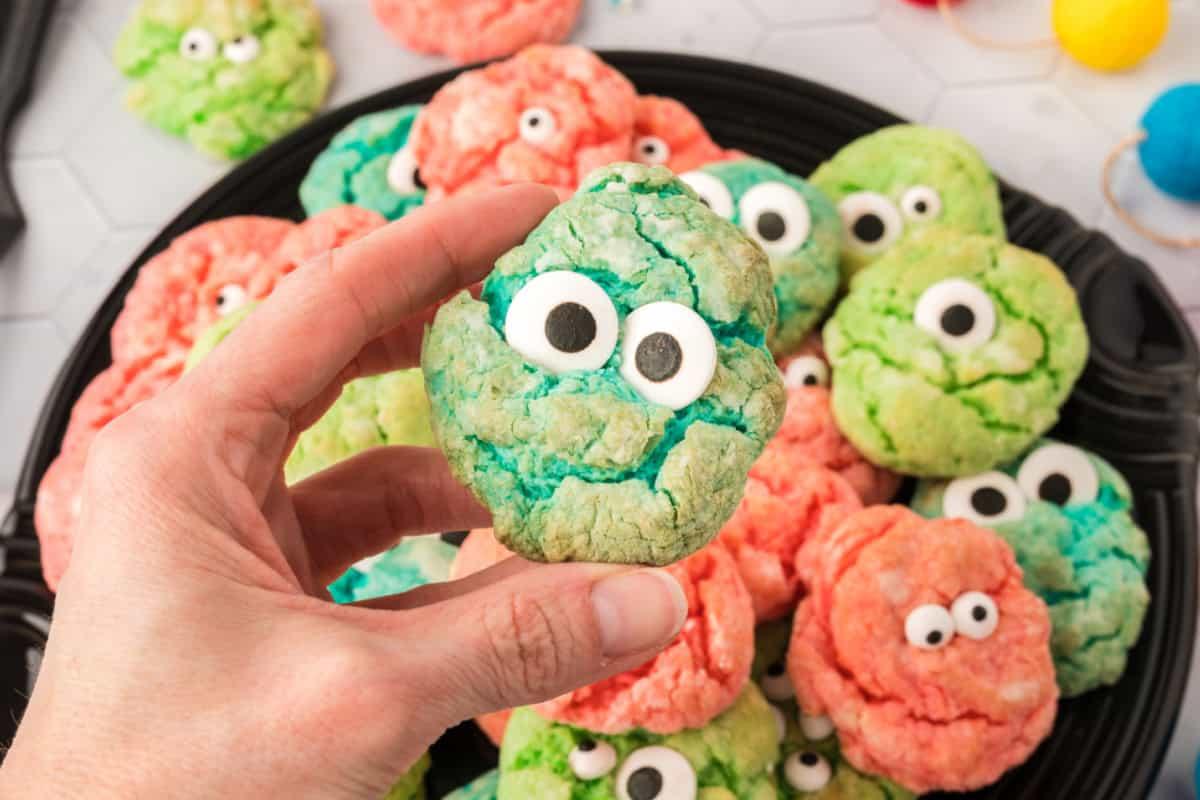 Halloween cookie platter with colorful monster eye cookies dotted with candy eyes in bright orange, green and purple