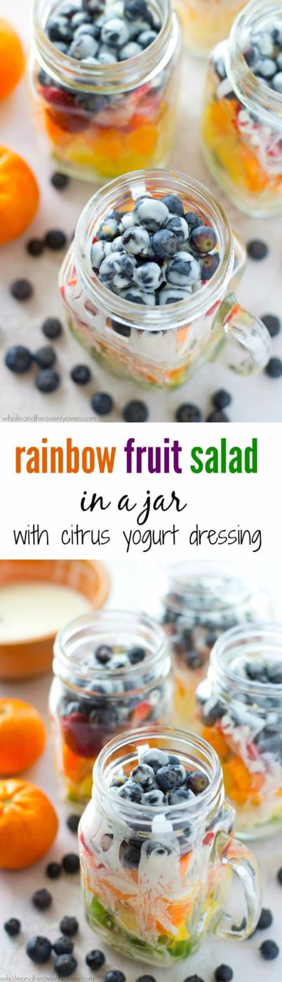 Rainbow fruit salad in a jar with layered pineapple, strawberries, kiwi and blueberries over citrus dressing
