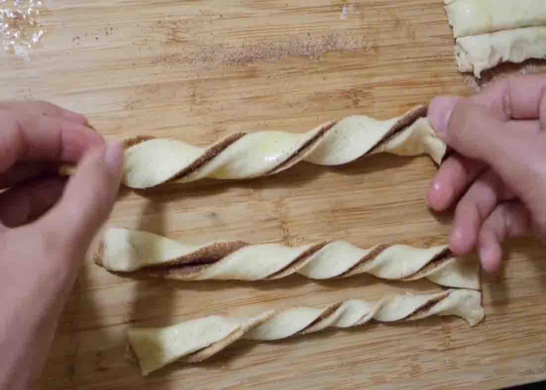 Twisting the churros made from pillsbury crescent rolls