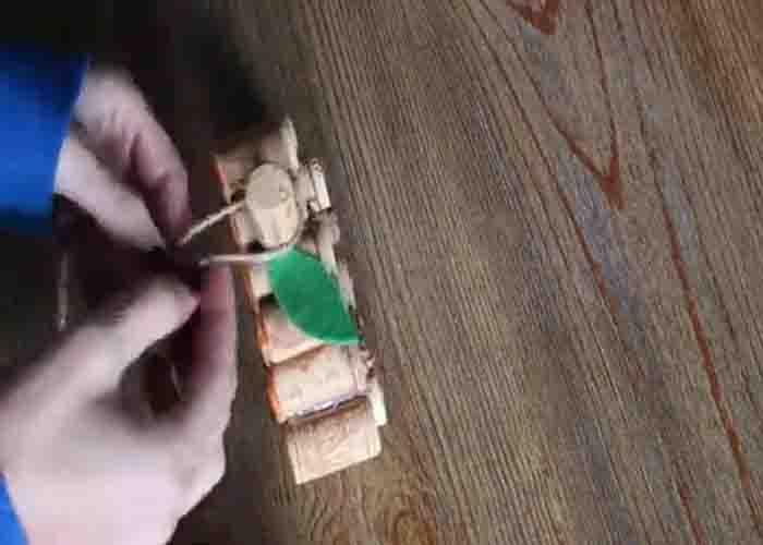 Tying the twine at the cork stem to complete the DIY cork pumpkin
