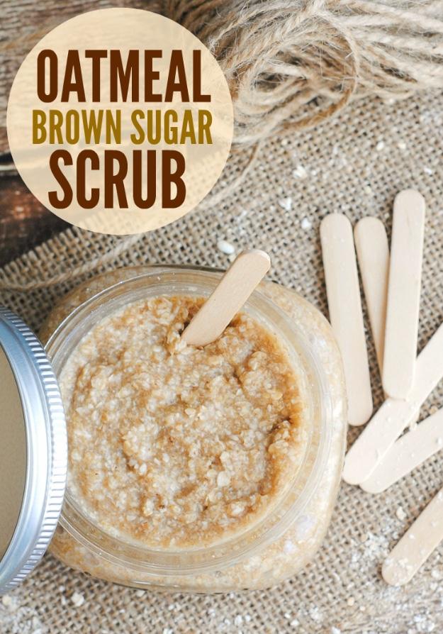 Oatmeal brown sugar scrub in an open jar with a wooden craft stick, more sticks and a metal lid on burlap