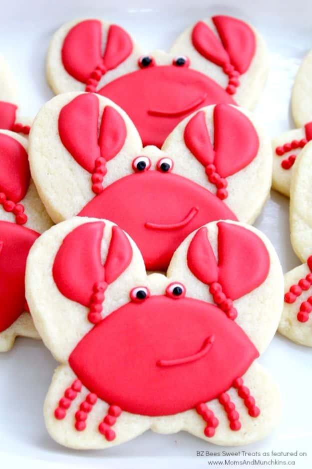 Crab cookies made with a butterfly cutter turned upside down, iced bright red with piped white candy eyes