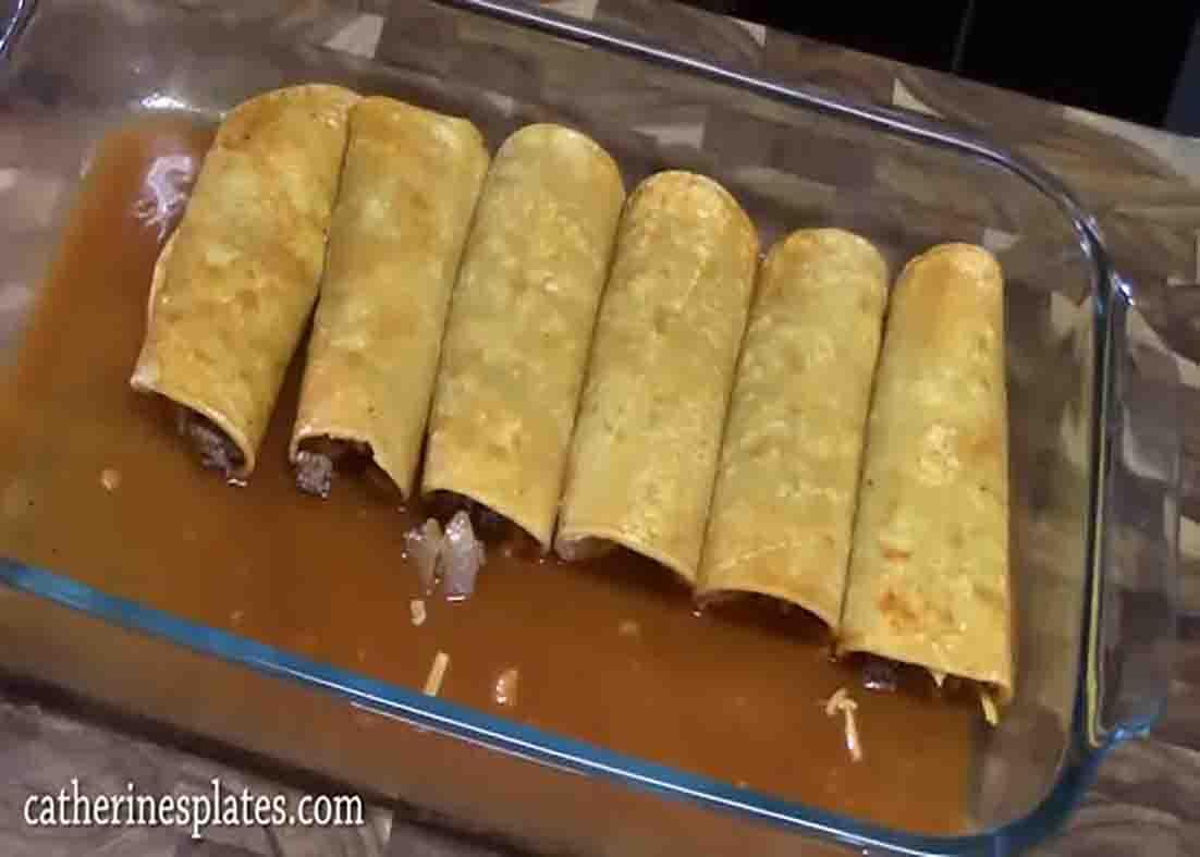 Assembling the beef enchiladas in the casserole dish