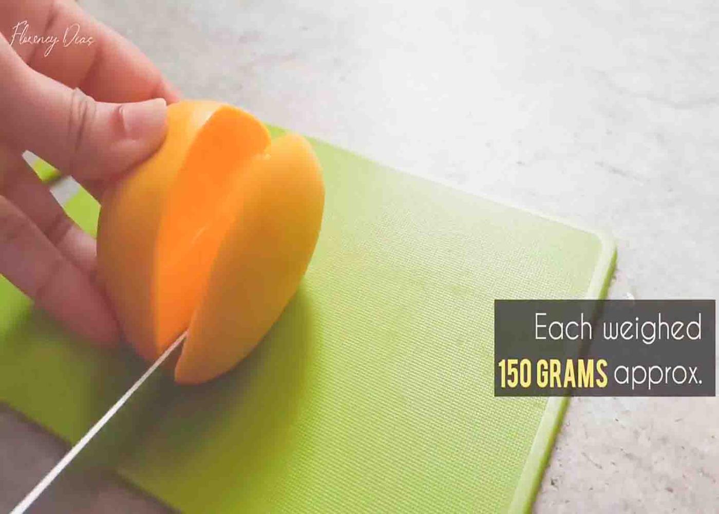 Cutting the mangoes to get the pulp