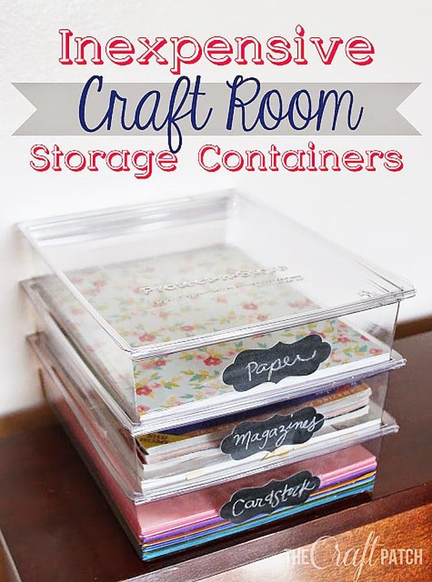 Stack of clear plastic document storage boxes on a desk holding paper and cardstock, with chalkboard label stickers