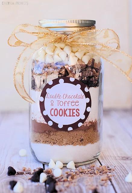 Quart mason jar layered with flour, brown sugar and chocolate chips for a Christmas cookie mix, tied with twine