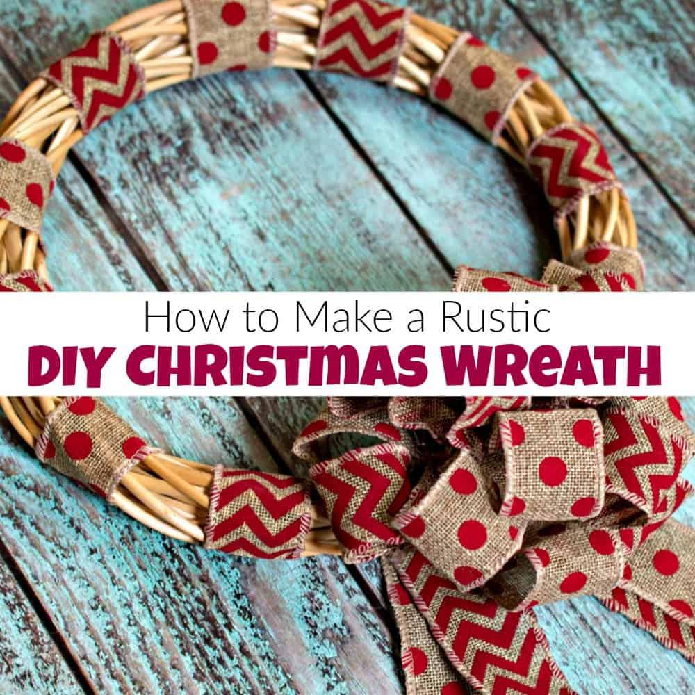 A willow wreath wrapped in bands of red polka dot and red chevron burlap ribbon with a loopy burlap bow on blue wood boards