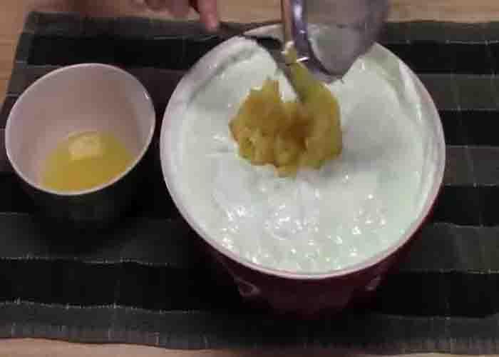 Stirring in the pineapple to the lime jello salad