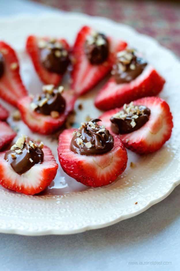Nutella deviled strawberries, halved strawberries piped full of Nutella and topped with chopped nuts