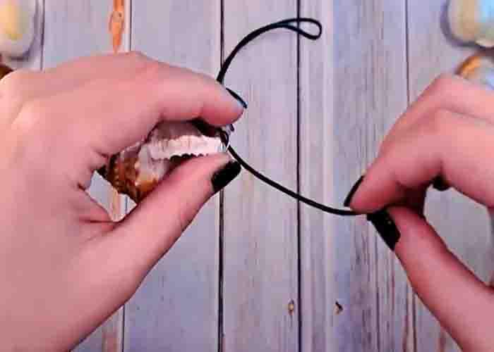 Adding the necklace cord to the glow in the dark necklace