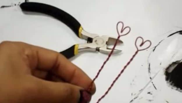 A lightbulb painted with a love message sitting on a small candy filled box, a DIY Valentine gift for him